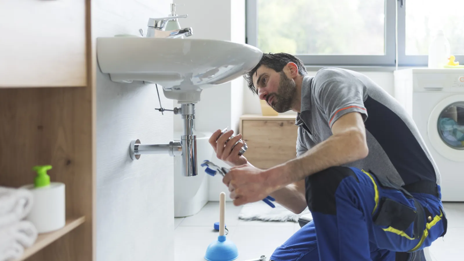 Plumber repairing a sink