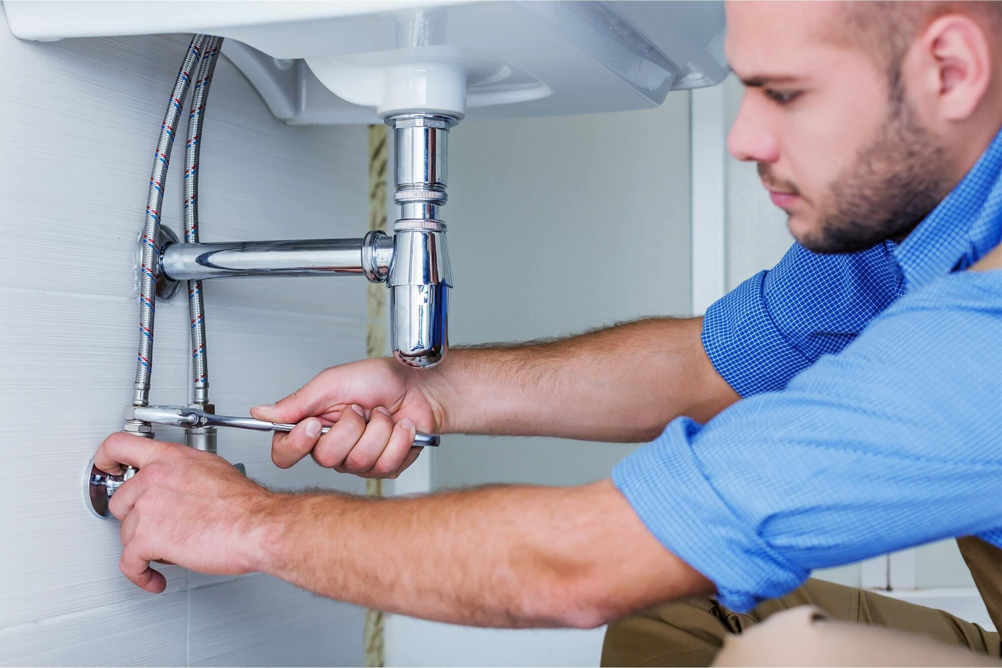 Plumber working on pipes